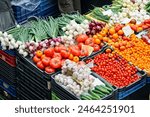 Colorful market stall with vegetables and fruits in a large food market in Budapest, Hungary.