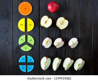 colorful math fractions and apples as a sample on brown wooden background or table. interesting math for kids. Education, back to school concept. Geometry and mathematics materials. - Shutterstock ID 1199919682
