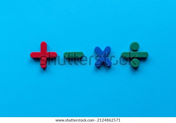 Colorful mathematical shape (Plus, minus,\
multiply, divide) on blue\
background.