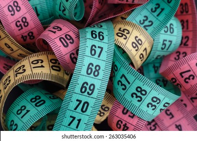 Premium Photo  Measuring tape with centimeters and inches on pink  background.