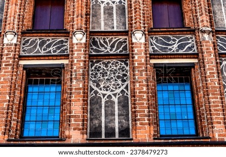 Colorful Medieval Windows Copernicus House Torun Poland.  Birthplace in 1453 of Nicolaus Copernicus, Scientist who discovered Sun Center of Solar System. 