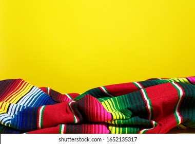 Colorful Mexican Serape Blanket On A Yellow Background