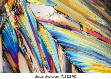 colorful microscopic shot of sugar micro crystals in polarized light