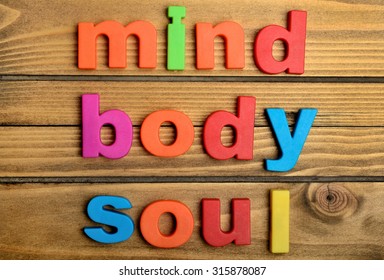 Colorful Mind Body Soul word on wooden table