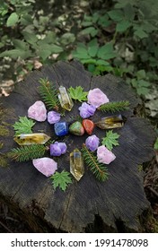 Colorful Mineral Gemstones And Leaves On Natural Forest Background. Magic Quartz Stones For Crystal Ritual, Esoteric Spiritual Practice. Wicca Altar. Top View