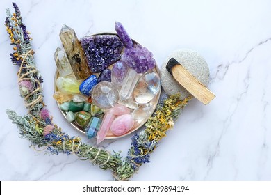 colorful minerals, palo santo, floral cleansing bundles on table. gemstones for esoteric spiritual practice, Healing Crystal Ritual, Witchcraft, Relax Chakra. Feng Shui, reiki therapy concept
