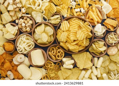 Colorful mix of salty snacks for beer varieties: chips and pretzels, onion rings and crackers. Non-healthy junk food background
 - Powered by Shutterstock