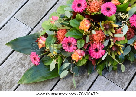 Colorful and mixed flower arrangement for cemetery or funeral. 