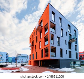 Colorful Modern Residential Apartment With Flat Building Exterior In Salzburg, Austria. New Luxury House And Home Complex Of Blue And Red Color. City Real Estate Property And Condo Architecture.