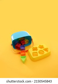 Colorful Montessori Sensorial Material Learning, Shape And Color Blocks With Bucket, Educational Toys, Thinking Process, Cognitive Skills, Learn Through Play Tools Concept On Yellow Background