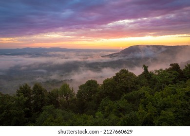 Colorful morning sunrise with golden glowing fog clouds over mountains at Arkansas Grand Canyon Scenic Point Overlook  - Powered by Shutterstock