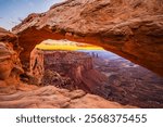 A colorful morning sunrise at the Mesa Arch in the Island in the Sky district of the Canyonlands National Park near Moab in Utah United States.