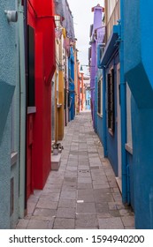 Colorful Narrow Alleyway in Murano Island in Venice - Shutterstock ID 1594940200