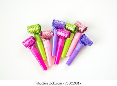 colorful New years Eve blowout noisemakers isolated on white - Shutterstock ID 755013817