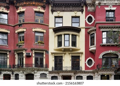Colorful New York townhouse facades with ornate cornice moldings