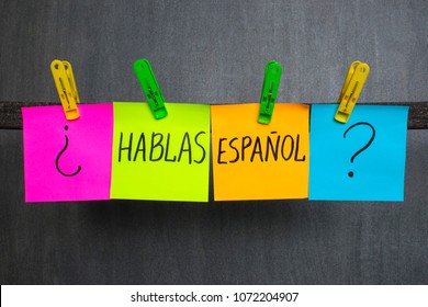 Colorful notes with words Do you speak Spanish on the dark background. 