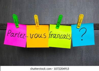 Colorful notes with words Do you speak French on the dark background. 