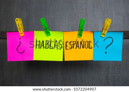 Colorful notes with words Do you speak Spanish on the dark background. 