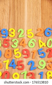 Colorful numbers on wooden background