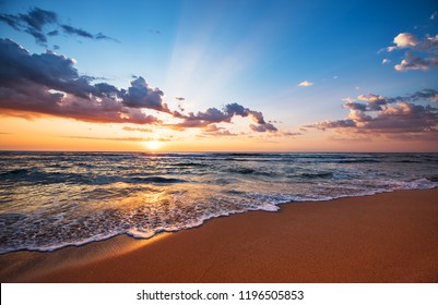 Colorful ocean beach sunrise. - Shutterstock ID 1196505853