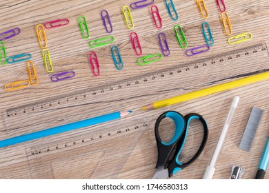 Colorful Office Paper Clips. Inscription School. White School Chalk. Wooden School Bench Top. School Accessories.