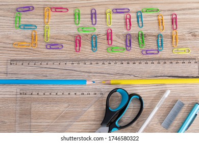 Colorful Office Paper Clips. Inscription School. White School Chalk. Wooden School Bench Top. School Accessories.