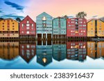 Colorful old houses over the Nidelva river at summer sunset in Trondheim, Norway
