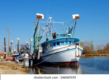 Colorful Old Wooden Shrimp Boat Trawlers Docked Along Bayou Lafourche In South Louisiana.