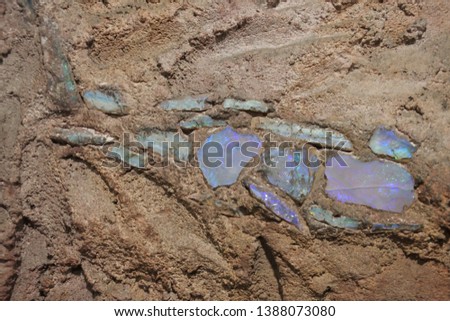 Colorful Opal stones inside a Sandstone mine wall. Stock photo © 