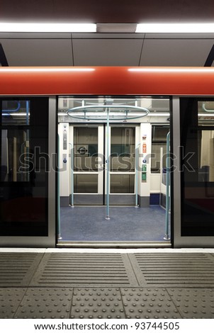 A colorful opened sliding mechanical door of the London Underground train at a tube station waiting for passenger.