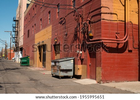 colorful orange alley way near the larson buidling in downtown yakima washington with dumpsters and garbage bins