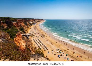 Colorful Orange Cliffs At Praia Da Falesia, Portugal.