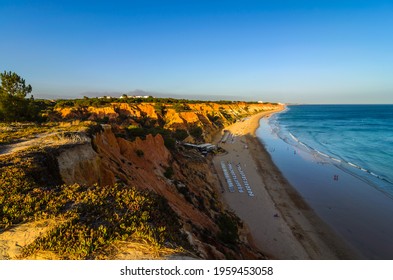 Colorful Orange Cliffs At Praia Da Falesia, Portugal.