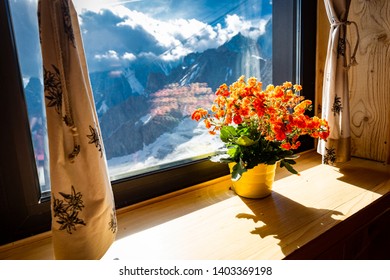 Colorful Orange Flowers Pot Window Sill, Alps Mountains Range Beautiful Landscape View, Inside Torino Hut Cabin, Italy, Travel Europe.