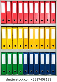 colorful ordners are neatly arranged, this ordner is used to store or archive documents in an office or company - Shutterstock ID 2317409183