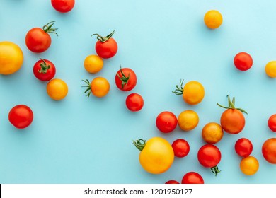 Colorful organic cherry tomatoes on a blue background, Marble Red and Golden Plum Holland cherry tomato