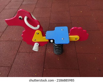 Colorful Outdoor Rocking Horse Toys in a residential garden.