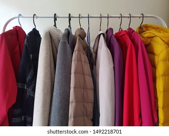 Colorful Outerwear Hanging On Rack.