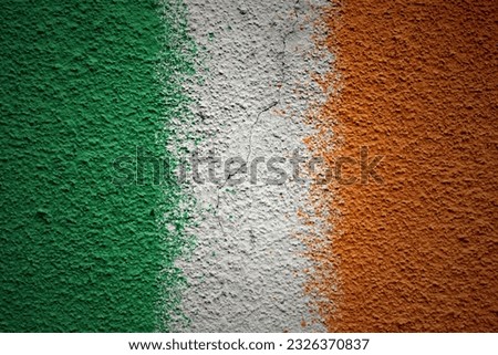colorful painted big national flag of ireland on a massive old cracked wall