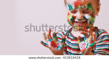 Colorful painted hands in a beautiful young girl