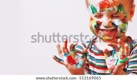Colorful painted hands in a beautiful young girl