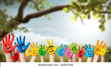 colorful painted hands in front of a spring scene