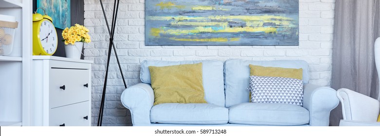 Colorful Painting On A White Brick Wall In Cozy Living Room