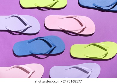 Colorful pairs of flip flops on purple background - Powered by Shutterstock