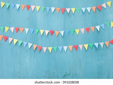 Colorful Paper Bunting On Rustic Wooden Background