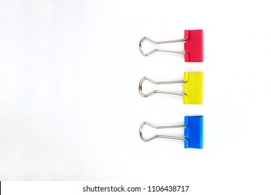 Colorful of paper clamps (red,yellow,blue) collection of education office supplies, top view, closeup, abstract texture background