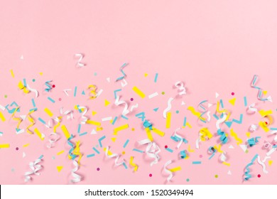 Colorful Paper Confetti Exploding On Pastel Pink Background