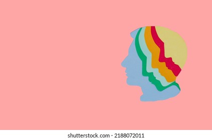 Colorful Paper Head With Multiple Faces On Pink Background, Next To Head Copy Space, Creative Art Design