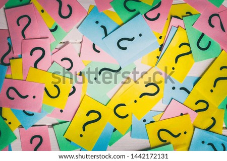 colorful paper notes with question marks. Closeup.