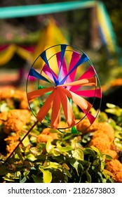 Colorful Paper Pinwheel. Paper Windmill Spinner Placed On
Green Bushes With Flowers. Wedding Decoration Scenes